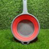 Collapsible colander folded flat on kitchen counter