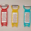 Set of kitchen tools including peeler, grater, and cutter for vegetables